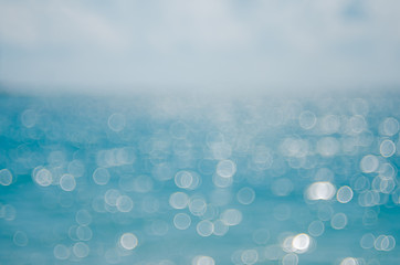 Wall Mural - blur tropical beach with bokeh sun light wave abstract background.
