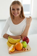 Wall Mural - Beautiful Woman With Fruits In Kitchen. Nutrition And Vitamins