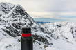 Red and black thermos in the mountains.