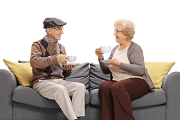 Mature man and woman with cups looking at each other