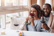 © Viacheslav Yakobchuk - Delighted African American couple hugging in the restaurant