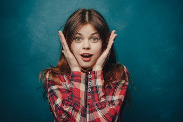 Pretty red-haired woman on a blue background
