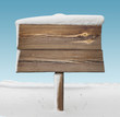 Wooden signpost with less snow and blue sky