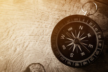 Compass On Wooden Table In Vintage Style For Background

