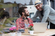 © Fergus Coyle - Gay couple sat sharing laptop outside cafe