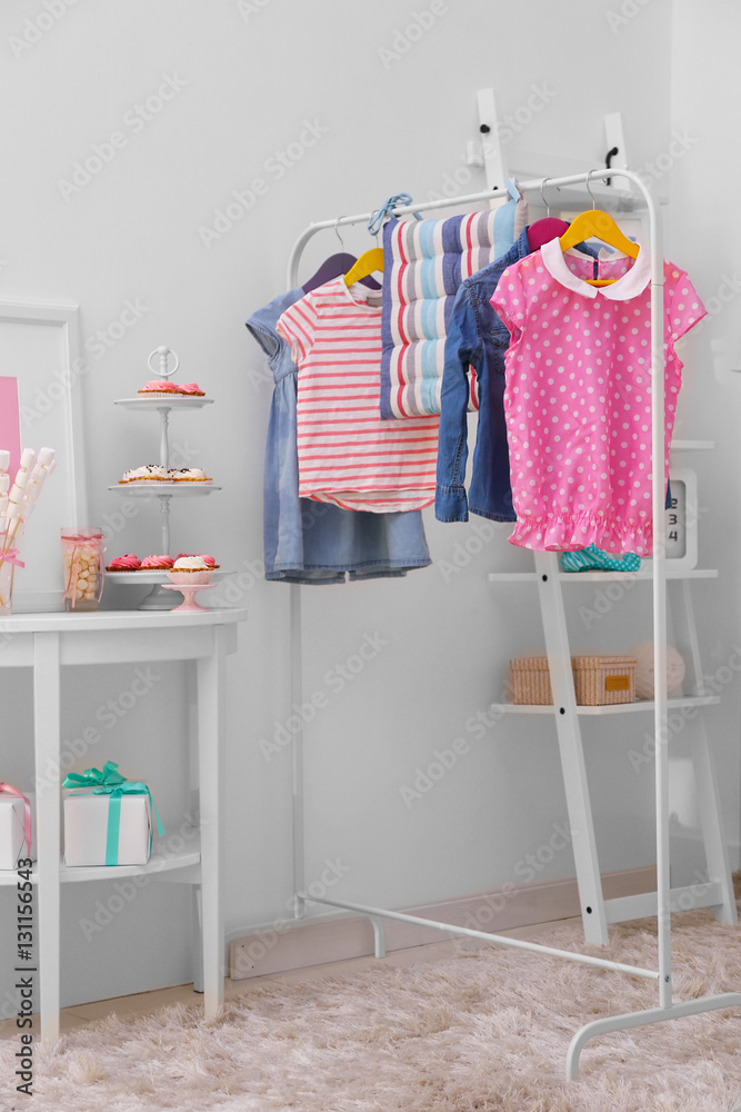 Children clothing on hanger stand in dressing room