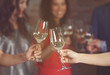© Africa Studio - Female hands toasting with glasses of white wine, closeup