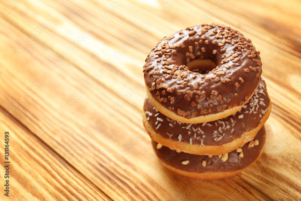 Tasty donuts on wooden table