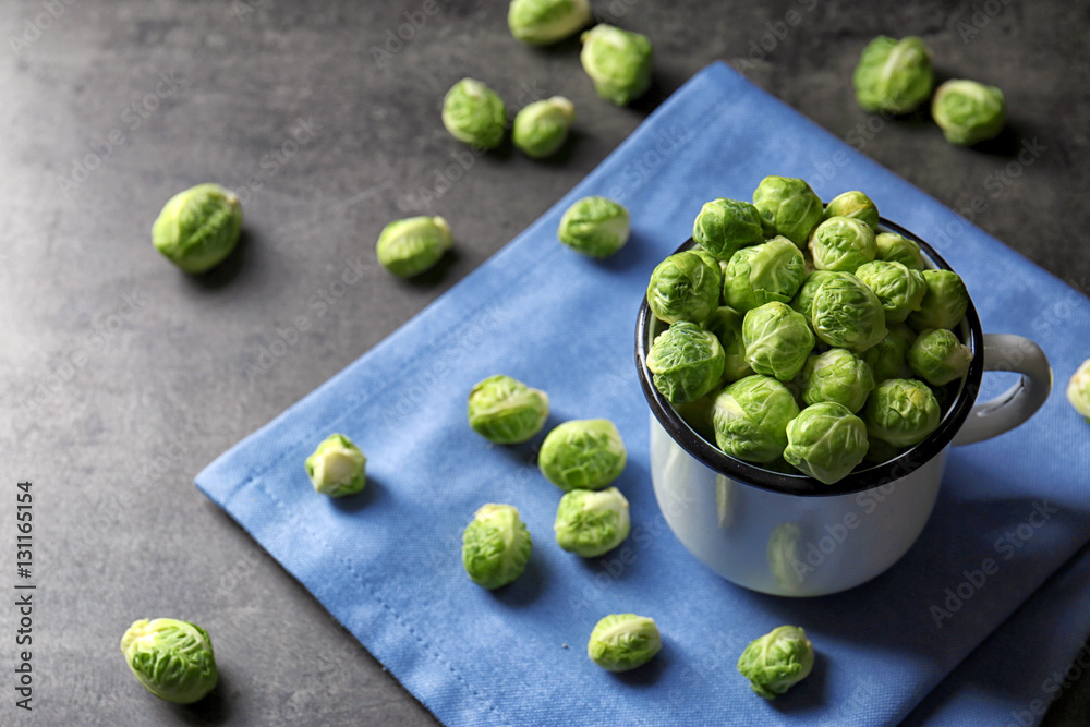 Brussels sprouts in metal mug on table