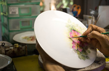 Old Woman Hand Painting Flower On Ceramic Plate
