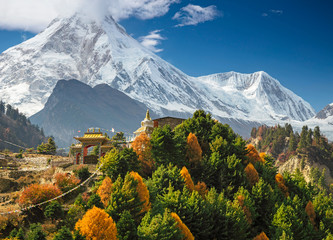 buddhist monastery and manaslu mount in himalayas, nepal. view from manaslu circuit trek