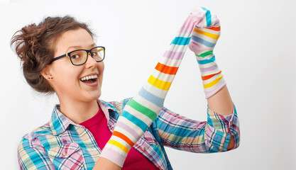 Young female holding two colorful socks