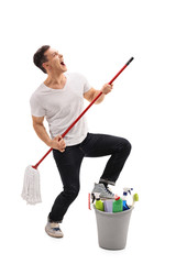 Poster - Young man pretending to play the guitar on a mop