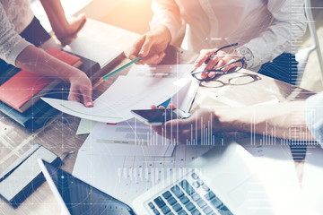 Fototapete - Business team brainstorming in office. Marketing plan researching. Paperwork on the table, laptop and mobile phone. Statistic graph overlay, icon innovation interface