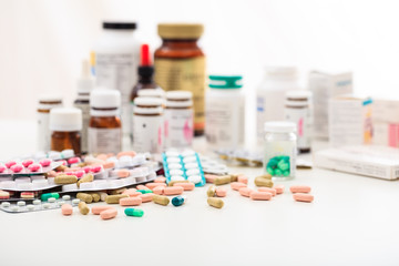 Wall Mural - Stack of pills and containers on white background