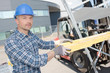 © auremar - Worker loading wood on to forklift