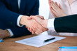 © rogerphoto - Business people shaking hands finishing up a meeting