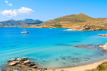 Catamaran boat saiing on azure sea in Monastiri bay on Paros island, Greece