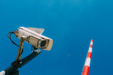 Surveillance Camera And Loudspeaker With Jump Tower On Background
