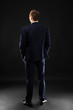 © Africa Studio - Young business coach standing on black background