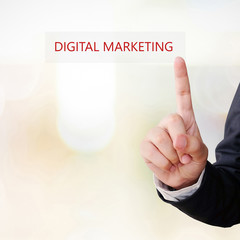 Businessman hand touch digital marketing word over blur backgrou