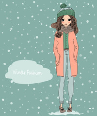 Wall Mural - cute winter greeting card with a young beautiful girl wearing warm clothes and winter background