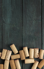 Wall Mural - Wine corks on dark wooden texture with copyspace