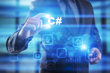 businessman selecting c# on virtual screen.