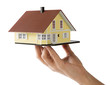 © uwimages - Model house in female hand isolated on white background, for mortgage concept.