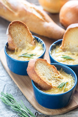 Wall Mural - Bowls of onion soup on the wooden board