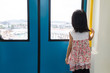 Leinwandbild Motiv Asian Chinese little girl inside train looking beside the window