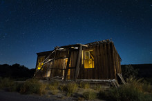 Old Abandoned Shack At Night Under A Starry Nevada Sky.
