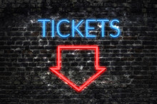 Tickets Neon Sign On Dark Brick Wall Background