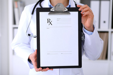 Close-up of a female doctor is showing empty medical prescription form