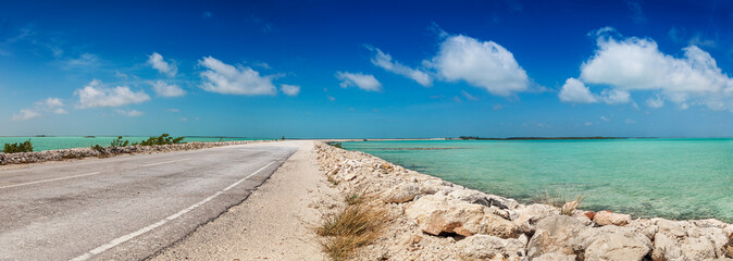 Wall Mural - Part dirt, part pavement - the causeway between North and Middle Caicos curves through the shallow turquoise waters of the Caicos banks