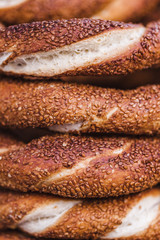 Wall Mural - Turkish bagel simit close up. Fresh baked pastries for sale on t