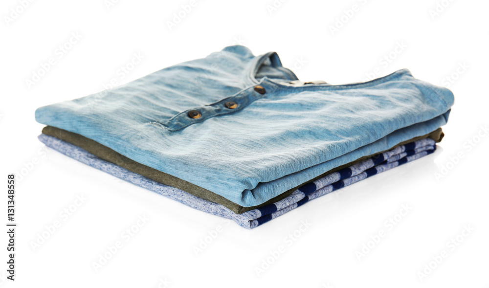 Stack of colorful t-shirts on white background