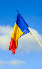 Romanian Flag in the sun, National Day of Romania, blue sky close up