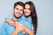 © deagreez - Portrait of happy cute lovers embracing on gray background