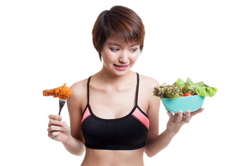 Wall Mural - Beautiful Asian healthy girl with salad and  fired chicken