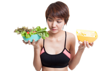 Wall Mural - Beautiful Asian healthy girl salad and potato chips.