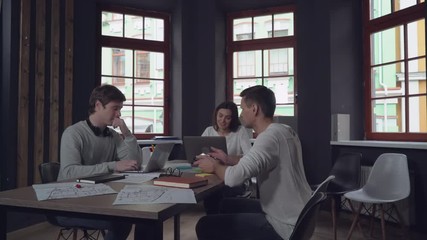 Aufkleber - Meeting in the contemporary office. Happy young group of people discussing new design project at the working place. Caucasian professional coworkers have brainstorming session in the morning at work