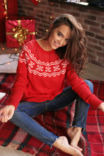 Christmas Photo Of Beautiful Woman With Dark Hair In Cozy Clothes Posing At Home