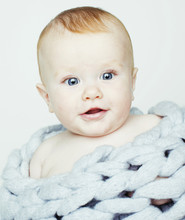 Little Cute Red Head Baby In Scarf All Over Him Close Up Isolate