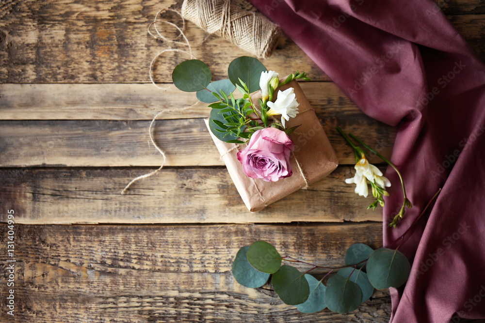 Handcrafted gift box with flowers on wooden table