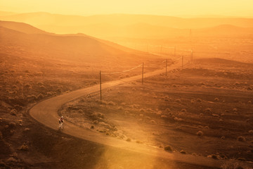 Lonely cyclist in the dessert