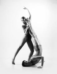 Wall Mural - Young ballet dancers on a white background