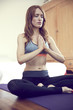 © Westend61 - Redheaded woman doing yoga exercise at home