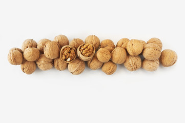 Wall Mural - Walnuts on white background. Walnuts at border of image with copy space for text. Top view. Vegetarian or healthy eating.