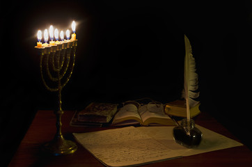 Poster - Old writing desk iluminated by menorah. Text in the notebook is in old Bulgarian ecclesiastical language and is written in the beginning of the past century. No copyright is applicable.